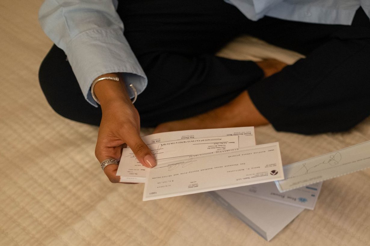 Hands holding personal checks